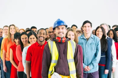 Portrait of confident construction worker and crowd